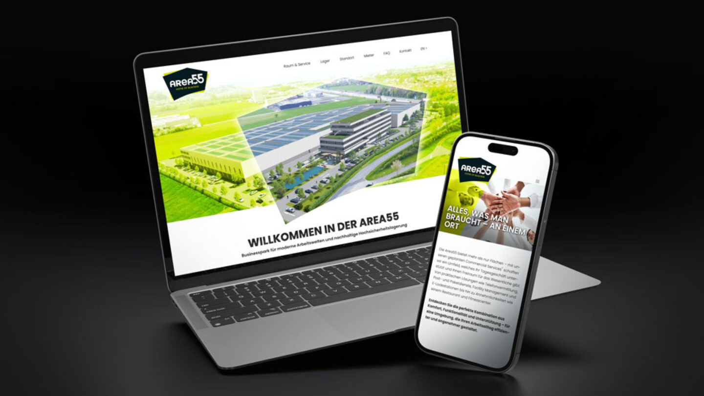 Laptop und Handy auf schwarzem Hintergrund mit leuchtender Landingpage.